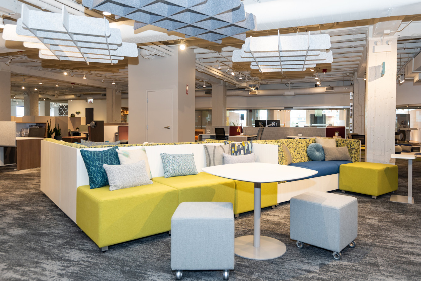 Preview of NeoCon 2021 Welcome Area with Custom PET Clouds suspended from ceiling, LB backless against LB Lounge Couch with 3 sides.&nbsp; Shown with Volker stools, Day-to-Day Disc Base Table, and Laptop Table