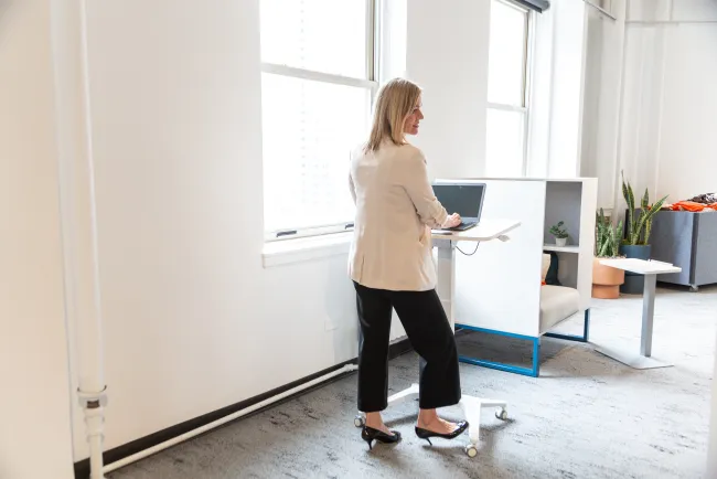 Sit-to-Stand Mobile Desk in use